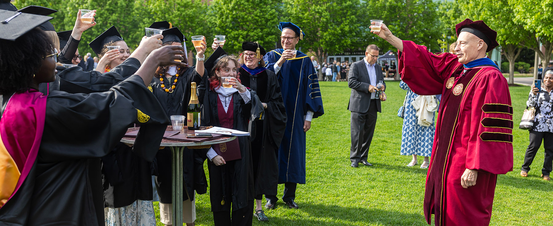 Professor Ted Karamanski raises a toast to graduating students in May 2023.