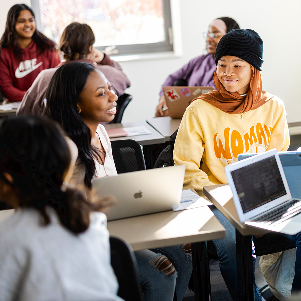 Loyola Students hold a group discussion during class