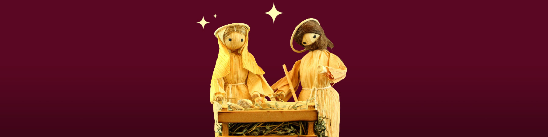 A creche depicting Joseph, Mary look over the baby Jesus in a cradle from the November 2024 Art and Faith of the Creche exhibit.